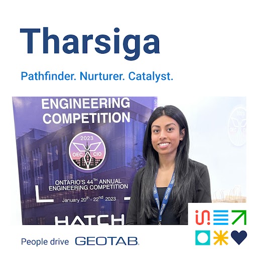 Tharsiga standing in from of a banner